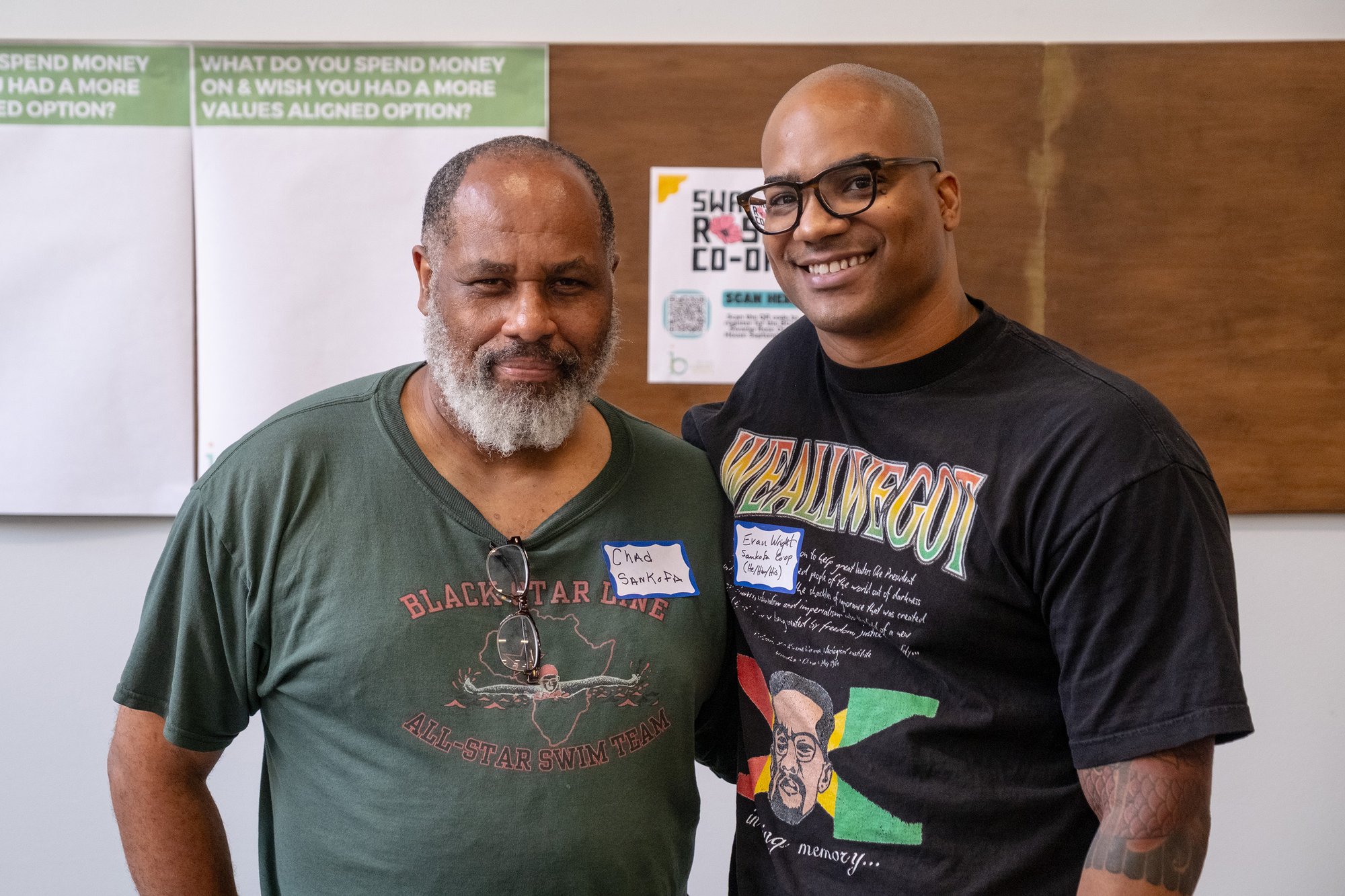 A photograph of two worker owners at Sankofa Bookstore and Cafe. A photograph of two worker owners at Sankofa Bookstore and Cafe.