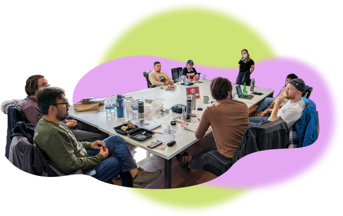 An image of a number of people around a table, engaged in a casual meeting. An image of a number of people around a table, engaged in a casual meeting.