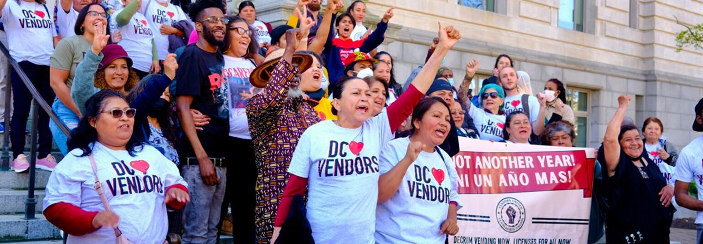 Street vendors rally together on the steps of a building. Many wear shirts that read "DC Loves Vendors." Street vendors rally together on the steps of a building. Many wear shirts that read "DC Loves Vendors."